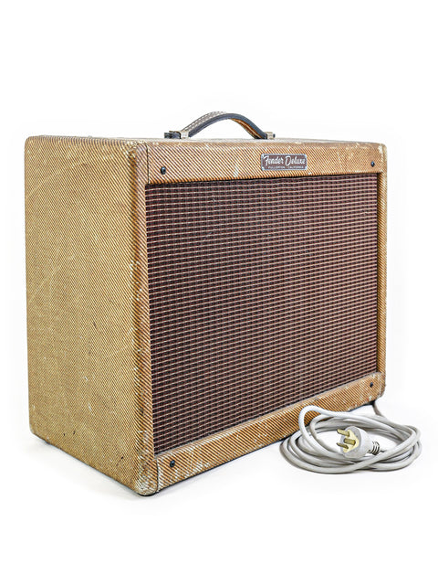 1959 Vintage Fender Tweed Deluxe 5E3 amp with a cord, showcased on a minimalist white background.