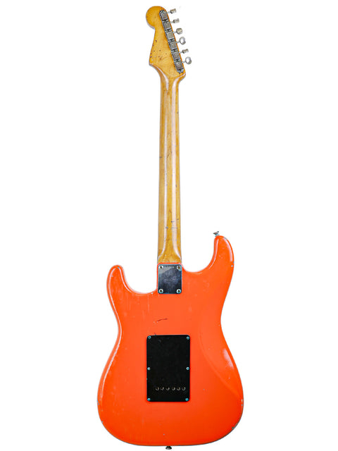 1963 Fender L-Series Stratocaster: an eye-catching orange electric guitar with a beautifully crafted wooden body.