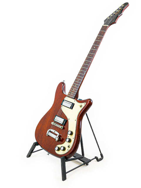 1966 Epiphone Wilshire guitar resting on a stand, set against a simple white background.