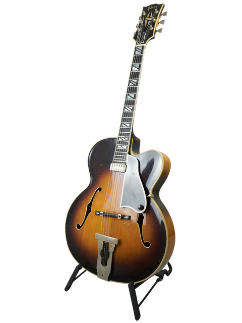 A 1966 vintage Gibson Johnny Smith guitar on a stand, showcasing its history with Ike Isaacs and George Benson.