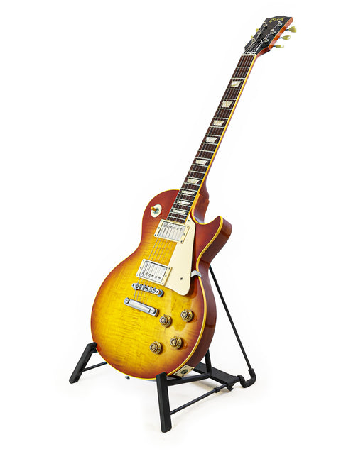 A 2004 Gibson Custom Shop 1959 Reissue Les Paul R9 guitar displayed on a stand with a white backdrop.