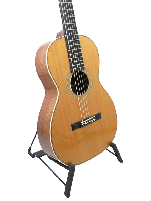 A 2011 Martin 0-28VS guitar resting on a stand, highlighting its beautiful wood finish and classic shape.