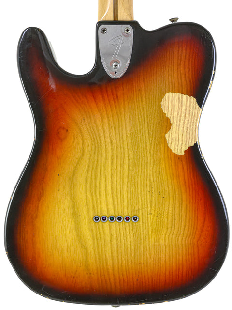 A Fender Telecaster guitar with a sunburst finish, model Custom, USA, from 1977, showcasing its classic design.