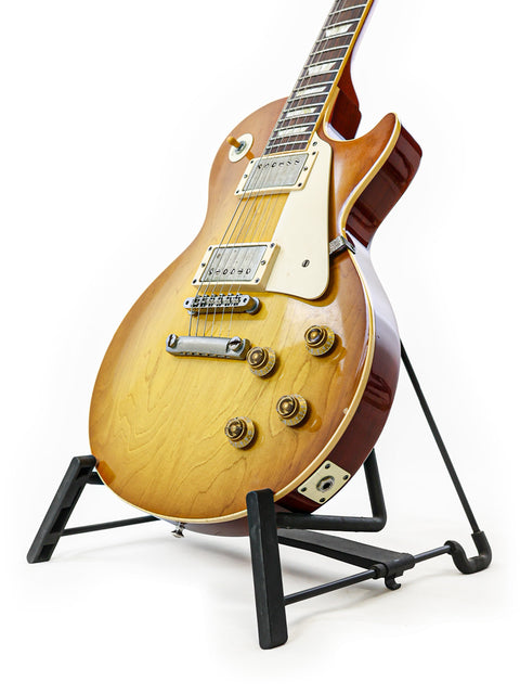 A Gibson Custom Shop LPR-8 1958 Les Paul Reissue guitar on a stand against a clean white background.