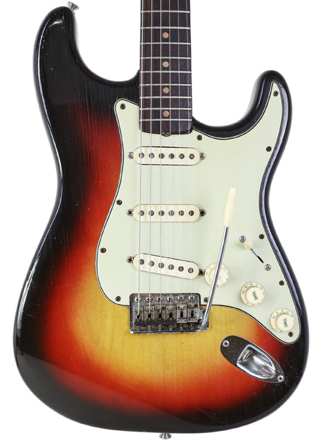 A beautiful sunburst-finished 1963 Fender L-Series Stratocaster, highlighting its vintage charm and iconic style.