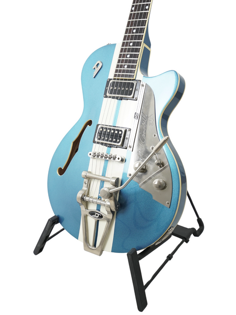 A blue semi-hollow electric guitar with a Bigsby bridge on a stand.