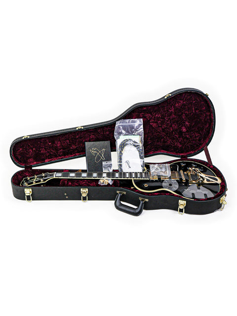 A guitar case containing a Gibson Custom Jimmy Page Les Paul Custom, highlighting its exclusivity and detailed craftsmanship.