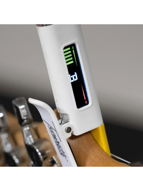 A guitar with the Original Tunerette™ clip-on tuner attached, designed for accurate tuning and convenience.