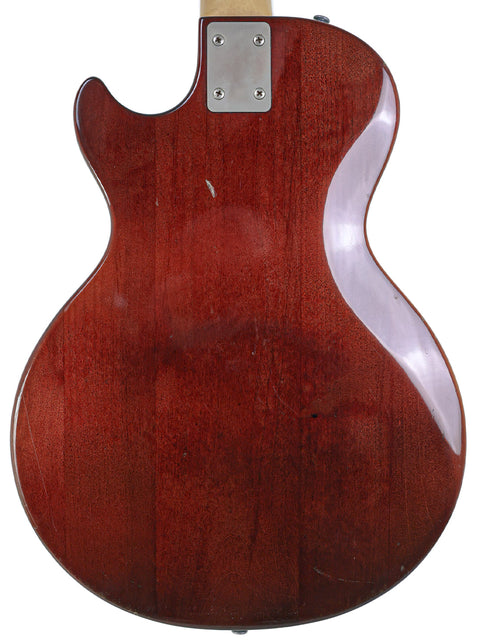 A red 1975 Gibson Marauder guitar, distinguished by its wooden back and neck, reflecting vintage American musical heritage.