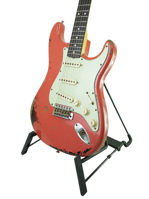 A red Fender Custom Shop '63 Michael Landau Stratocaster Relic guitar displayed on a stand against a white background.