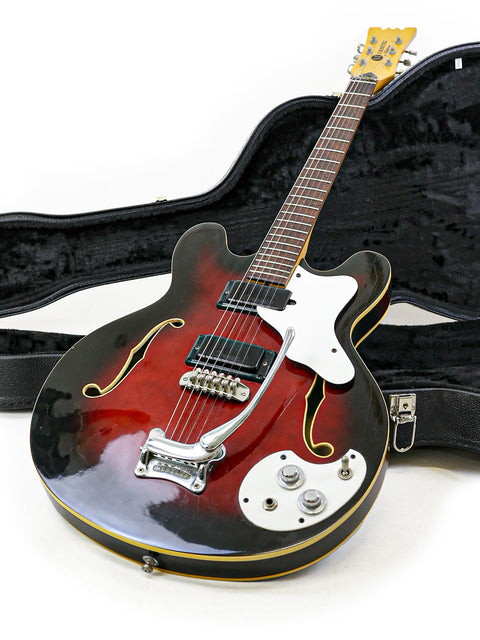 A red and black vintage Mosrite Celebrity III guitar from 1967, neatly placed in its case, perfect for collectors.