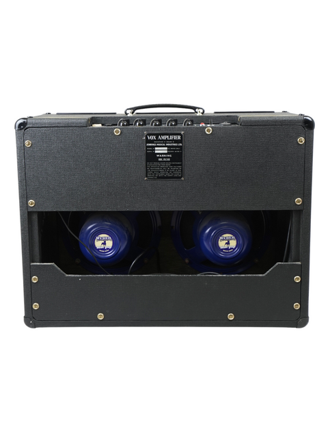 A sleek black Vox AC10 Twin amp from 1964, featuring vibrant blue speakers for a retro vibe.