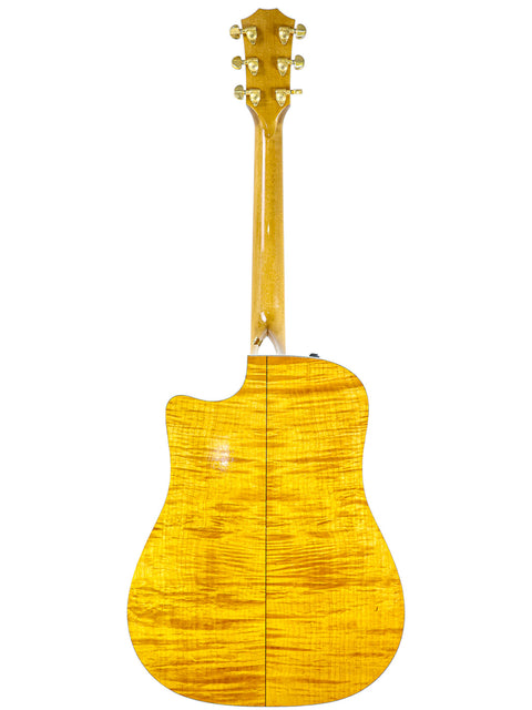 A vibrant yellow Taylor 610CE guitar from 2003, with a beautiful wooden back and neck, perfect for any music lover.