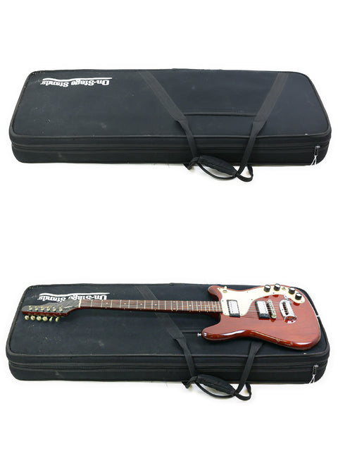 A vintage 1966 Epiphone Wilshire and another guitar in a case, with the case lid closed on top.