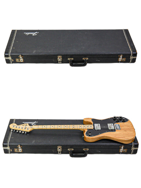 A vintage 1973 Fender Telecaster Deluxe and another guitar in a case, set against a simple white background.