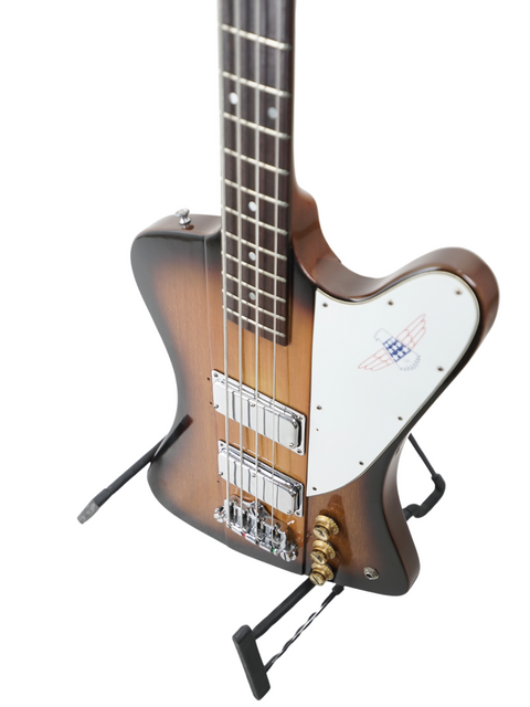 A vintage 1976 Gibson Bicentennial Thunderbird IV Bass on a stand, elegantly paired with a guitar strap.