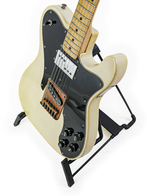 A vintage 1978 Fender Telecaster Custom electric guitar, white in color with a black pick guard.