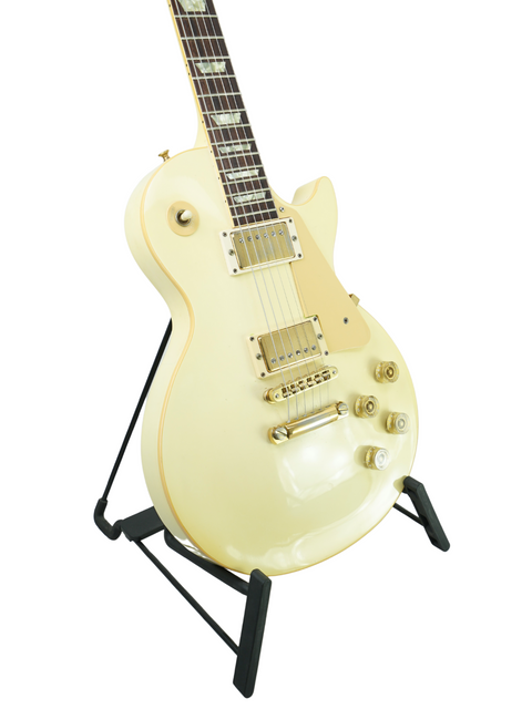 A vintage 1989 Gibson Les Paul Standard in Arctic White, prominently positioned on a stand.