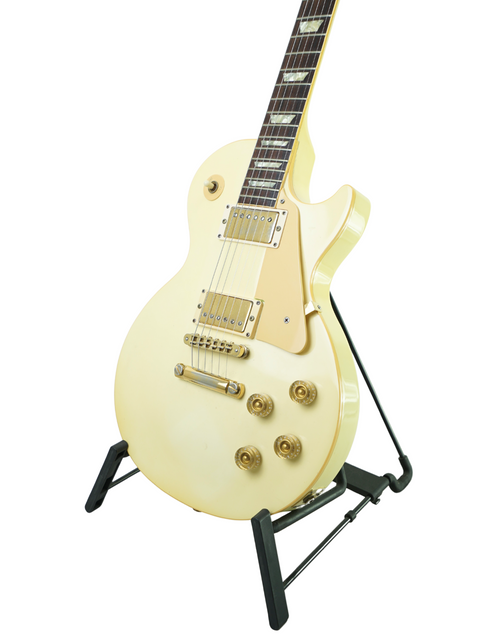 A vintage 1989 Gibson Les Paul Standard in Arctic White, prominently positioned on a stand for display.