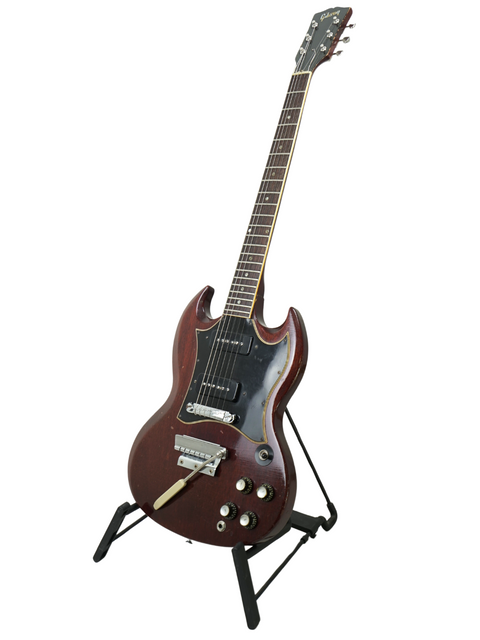 A vintage Gibson SG Special from 1967 is prominently featured on a stand.
