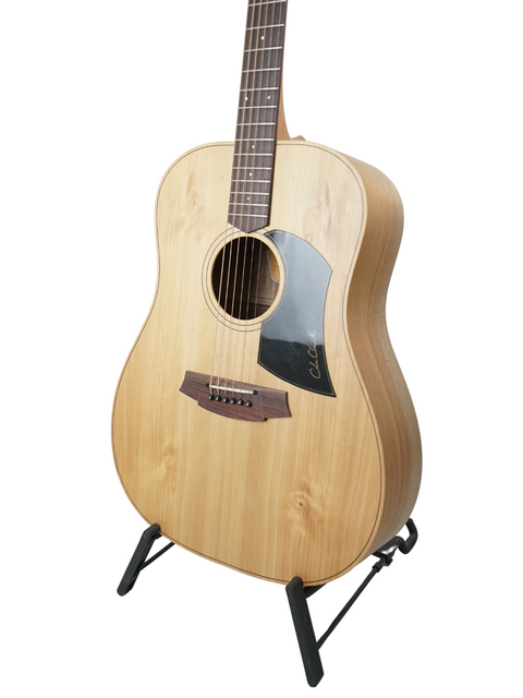 Acoustic guitar on a stand against a white background.