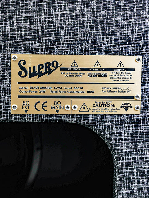 Back of a Supro Black Magick 1695T speaker cabinet label, featuring details about its 25W power and USA 2015 production.