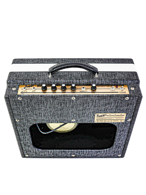 Black and white guitar amplifier with a white stripe, showcasing the Supro Black Magick 1695T, 25W Combo from 2015.
