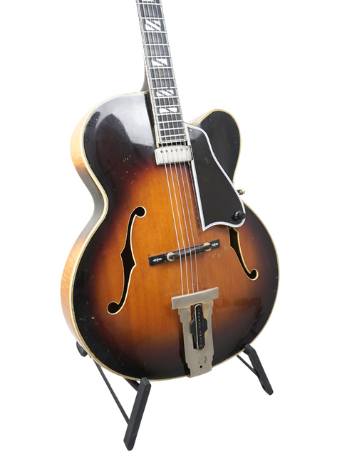 Classic 1966 vintage Gibson Johnny Smith guitar resting on a black stand, representing iconic craftsmanship and musical heritage.