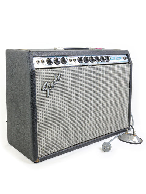 Classic 1977 Fender Deluxe Reverb amp featuring a microphone on top, ideal for vintage sound lovers.