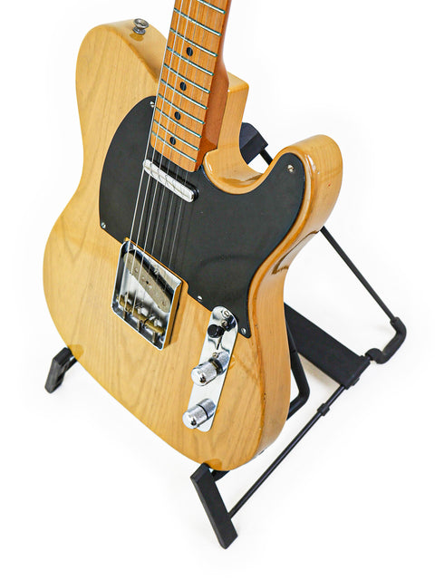 Classic 1982 Vintage Fender AVRI ‘52 Telecaster with a wooden body and a bold black pick guard, perfect for any musician.