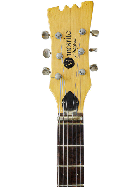 Close-up of a 1967 Mosrite Celebrity III guitar neck against a white backdrop, highlighting its vintage craftsmanship.