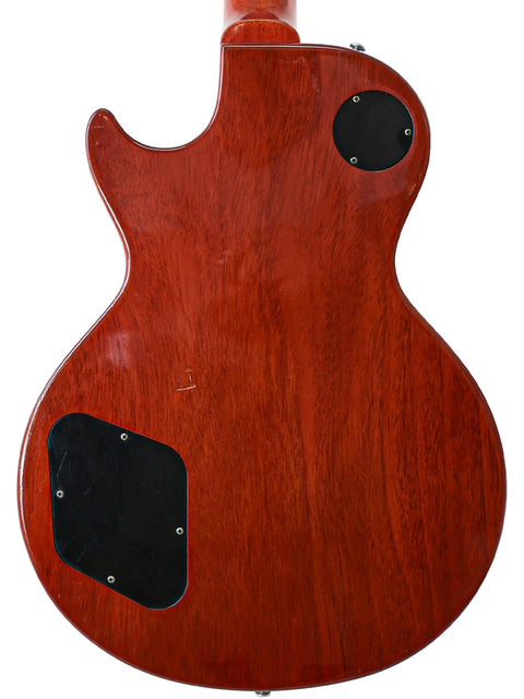 Close-up of a Gibson Custom Shop LPR-8 1958 Les Paul Reissue guitar showcasing its wooden body and black pickguard.