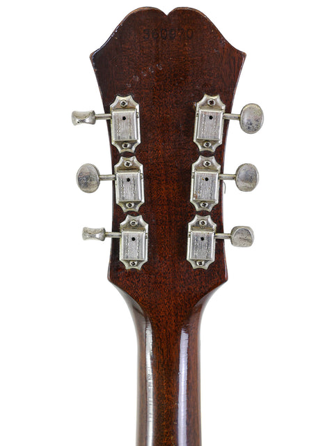 Close-up of the headstock from a 1965 vintage Epiphone Casino acoustic guitar, highlighting its unique features.