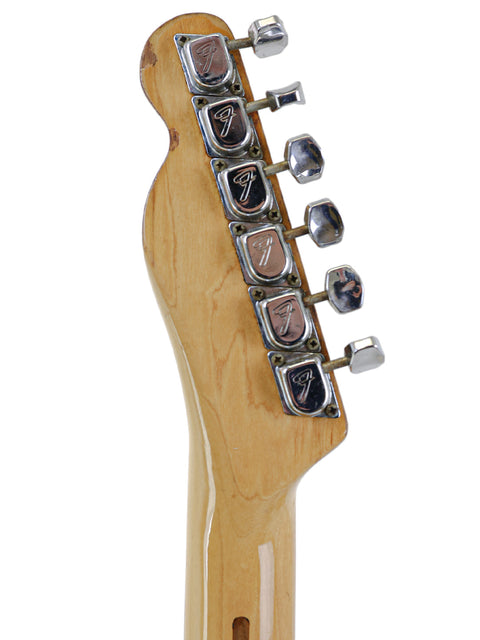 Close-up shot of a 1971 USA Fender Telecaster Thinline guitar head, highlighting its knobs and vintage appeal.