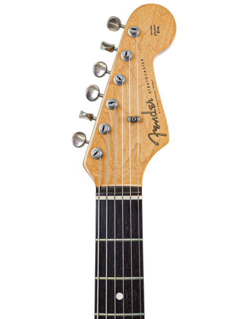 Close-up shot of a vintage 1982 Fender AVRI ‘62 Stratocaster guitar, focusing on the wooden headstock.
