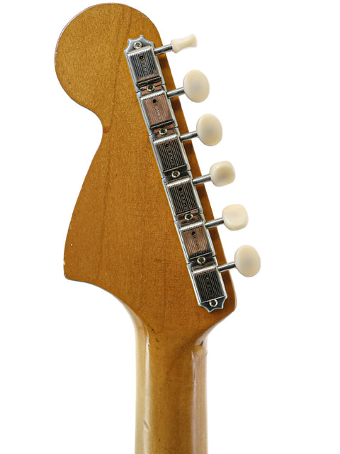 Detailed view of a Vintage Fender Musicmaster II guitar neck, complete with a white pickguard from USA, 1966.