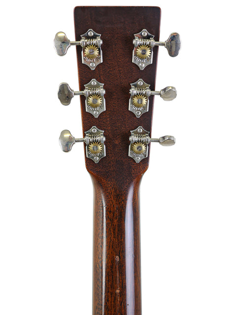 Detailed view of the headstock of a 2021 Martin 0-18 acoustic guitar, highlighting its classic shape and fine wood finish.