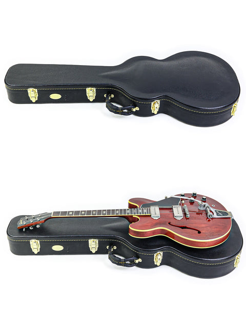 Display of two guitars in cases, including a vintage 1965 Gibson ES-330 made in the USA.