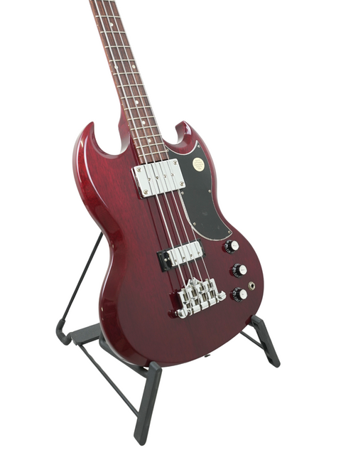 Eye-catching red electric bass guitar, the Gibson SG Standard Reissue from 2005, showcased on a stand for easy viewing.
