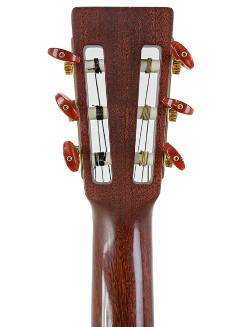 Image of the headstock of a 2003 Martin 000C-16SGCTNE acoustic guitar, featuring its distinctive shape and tuning hardware.