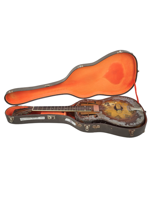 Inside a case, a vintage National Triolian mandolin rests alongside a guitar, blending styles from the USA in 1930.