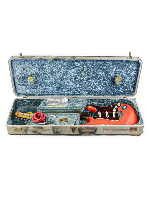 Inside a guitar case lies a 1963 vintage Fender L-Series Stratocaster, a perfect blend of history and musical artistry.