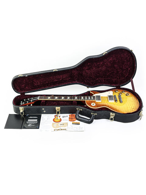 Inside a guitar case lies a Gibson Les Paul '59 Reissue from 2009, highlighting its iconic shape and rich wood finish.