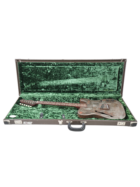 Inside view of a guitar case with luxurious green velvet lining, housing the James Trussart Steelcaster, USA, 2006.