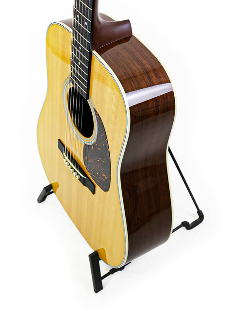 Martin D-28 CFM IV guitar on a stand, featuring a white background that highlights its limited edition craftsmanship.