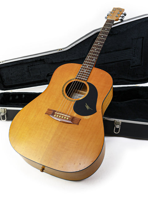 Maton M225 guitar from 1996, nestled in its case, set against a white backdrop.