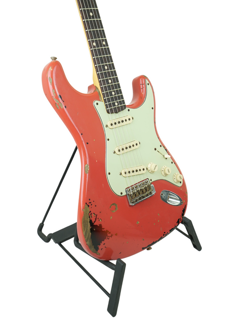Red Fender Custom Shop '63 Michael Landau Stratocaster Relic guitar on a stand, set against a clean white backdrop.