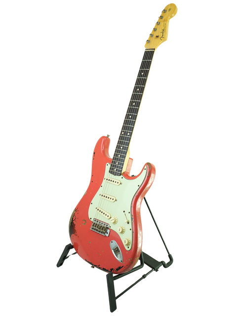 Red Fender Custom Shop '63 Michael Landau Stratocaster Relic guitar on a stand, set against a clean white backdrop.