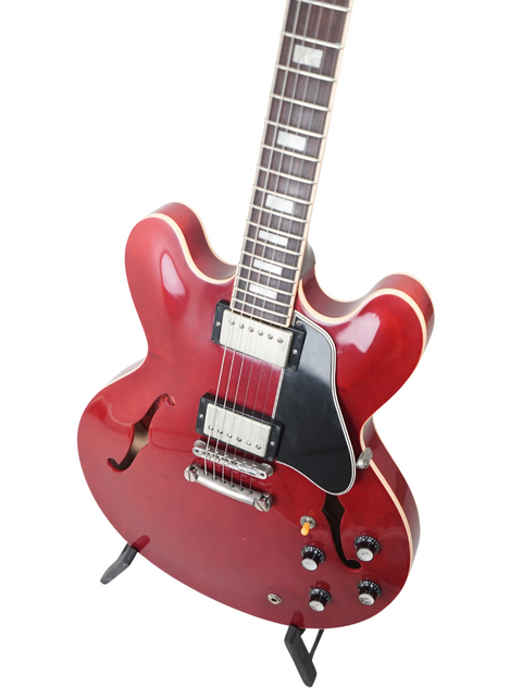 Striking red electric guitar with a classic black body, designed for those who appreciate craftsmanship and performance.