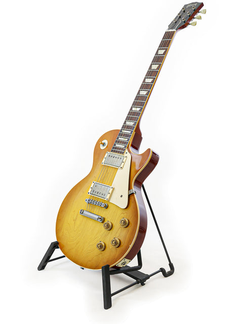 Stunning Gibson Custom Shop LPR-8 1958 Les Paul Reissue guitar displayed on a stand with a white backdrop.